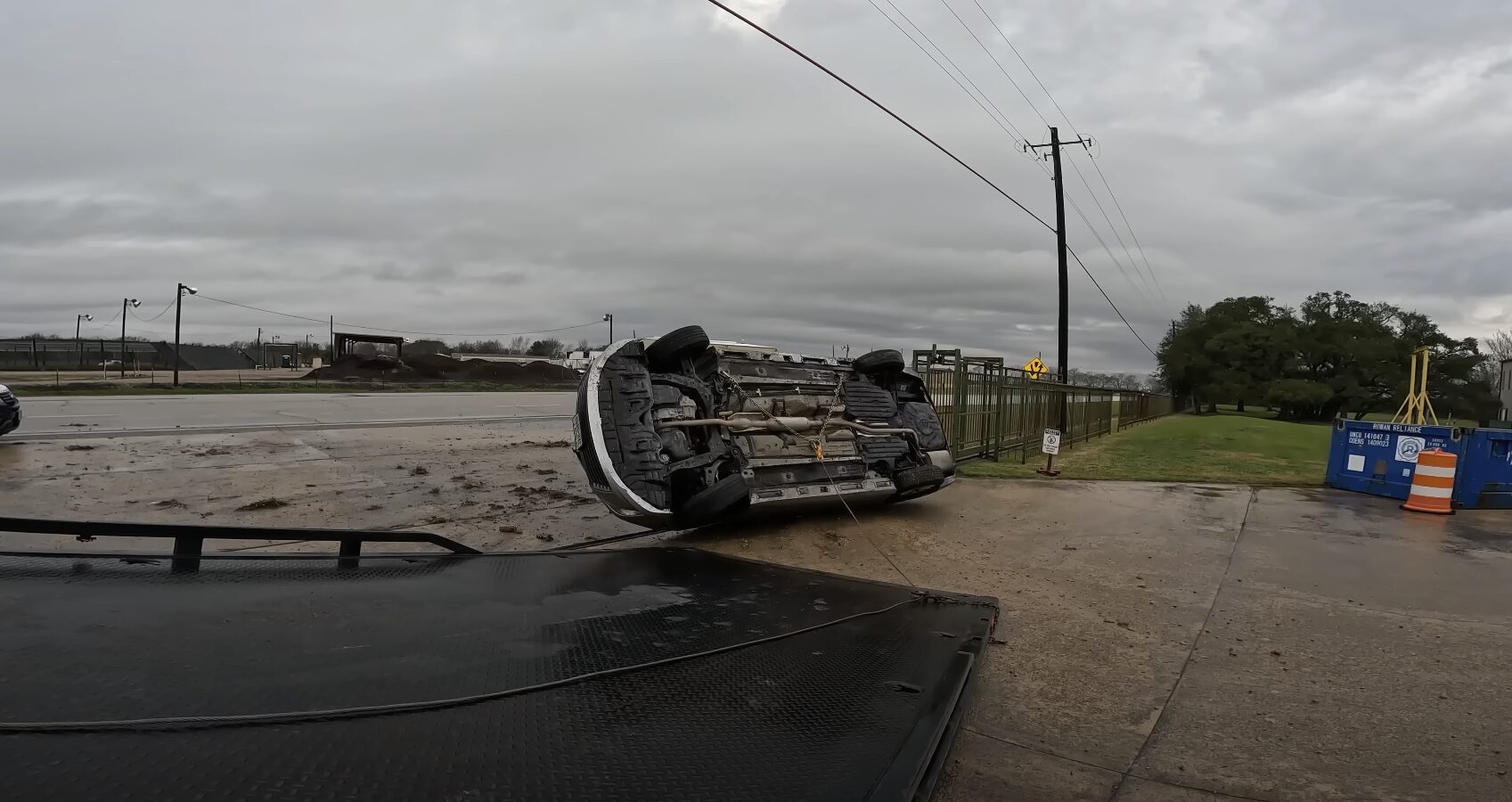 Overturned vehicle being recovered by professional towing service