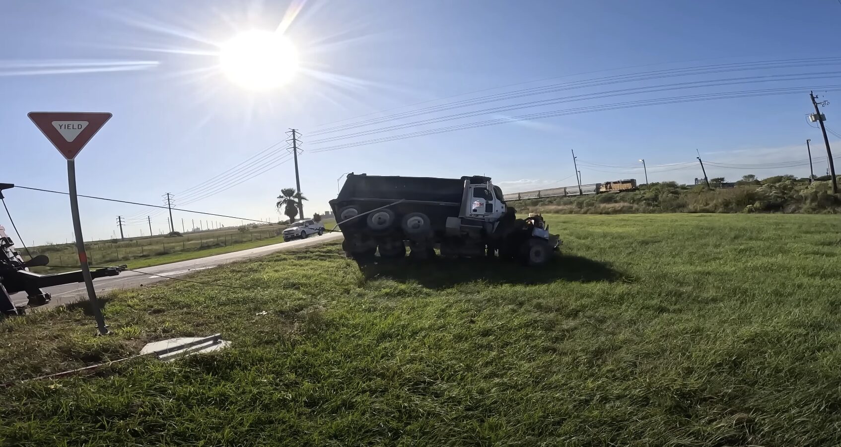 Heavy-duty tow truck recovering overturned vehicle